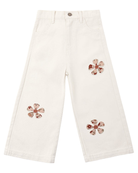 White pants with floral embellishments on a white background